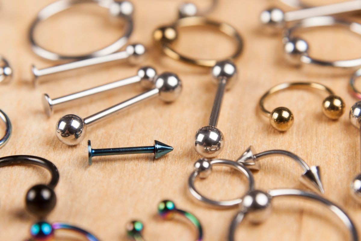 piercing earrings, on a wooden background